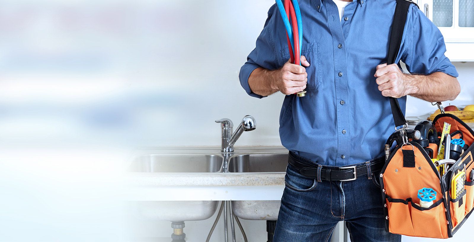 A Team Plumbing and Heating - Plumber Holds Tool Bag and Sink Pipes