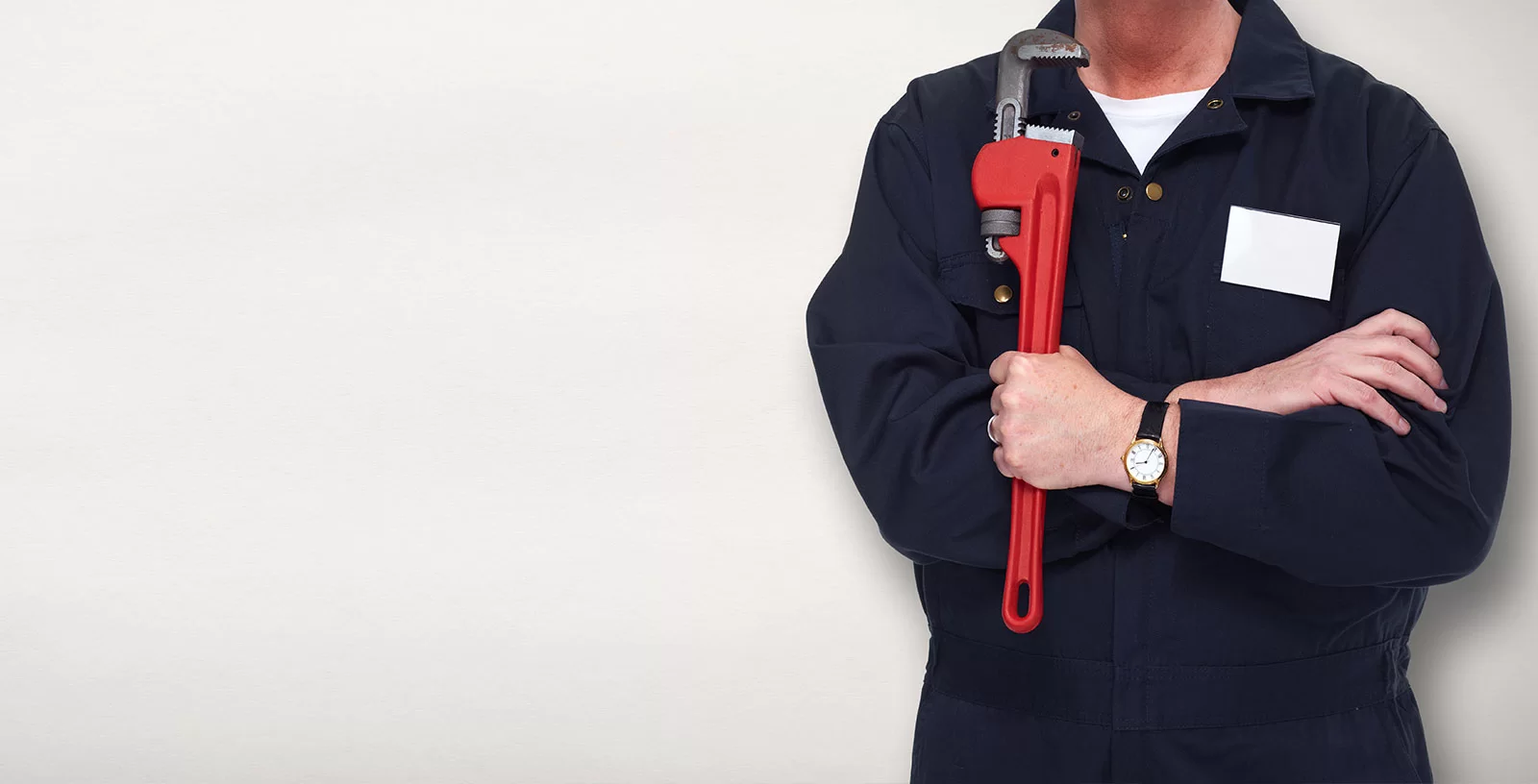 A Team Plumbing and Heating - Plumber holds a red spanner